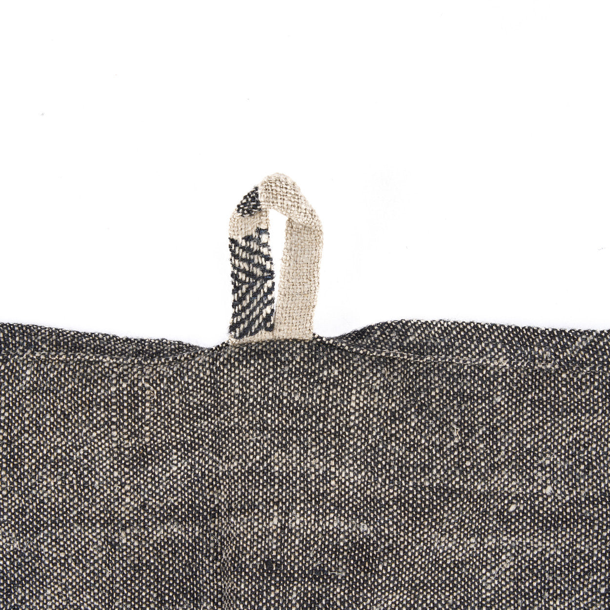 Artisan-crafted linen kitchen towel with subtle black dash stripes on natural fabric, soft and absorbent for daily use