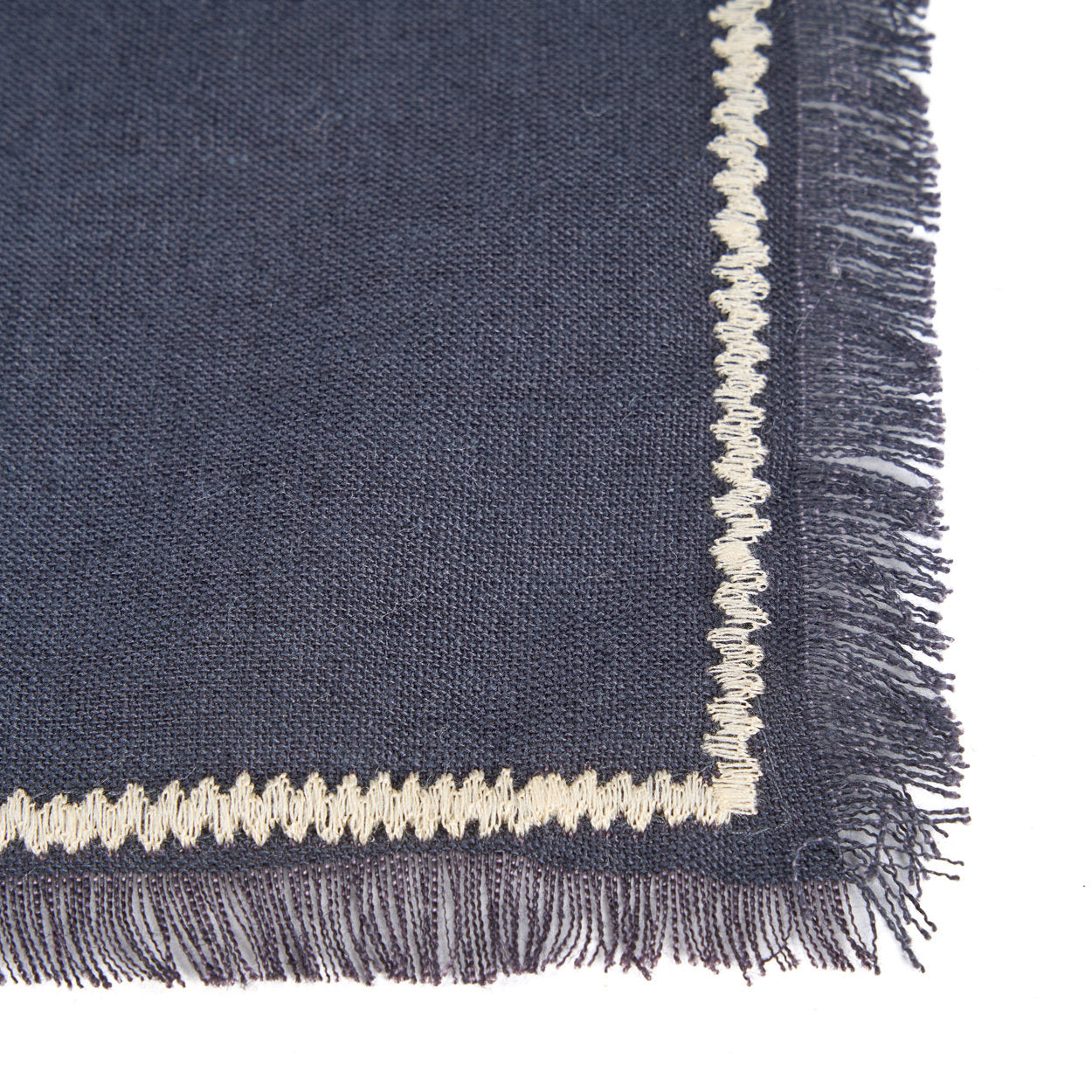 Artisan-crafted black linen napkin with subtle white stripes, soft and durable for everyday dining or special occasions