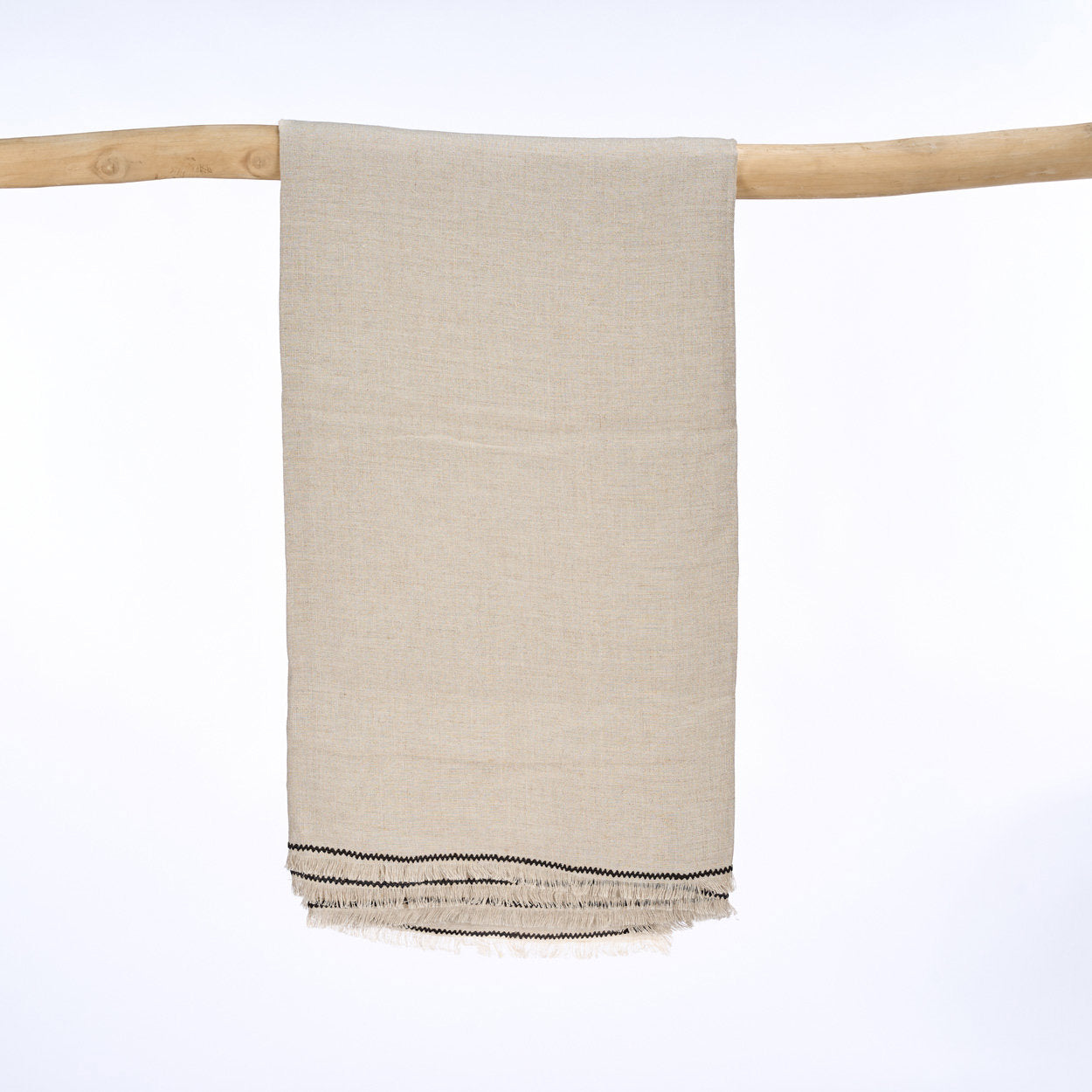 The Tuscany Tablecloth in natural black linen, 150x300 cm, perfect for adding warmth and elegance to your dining space.