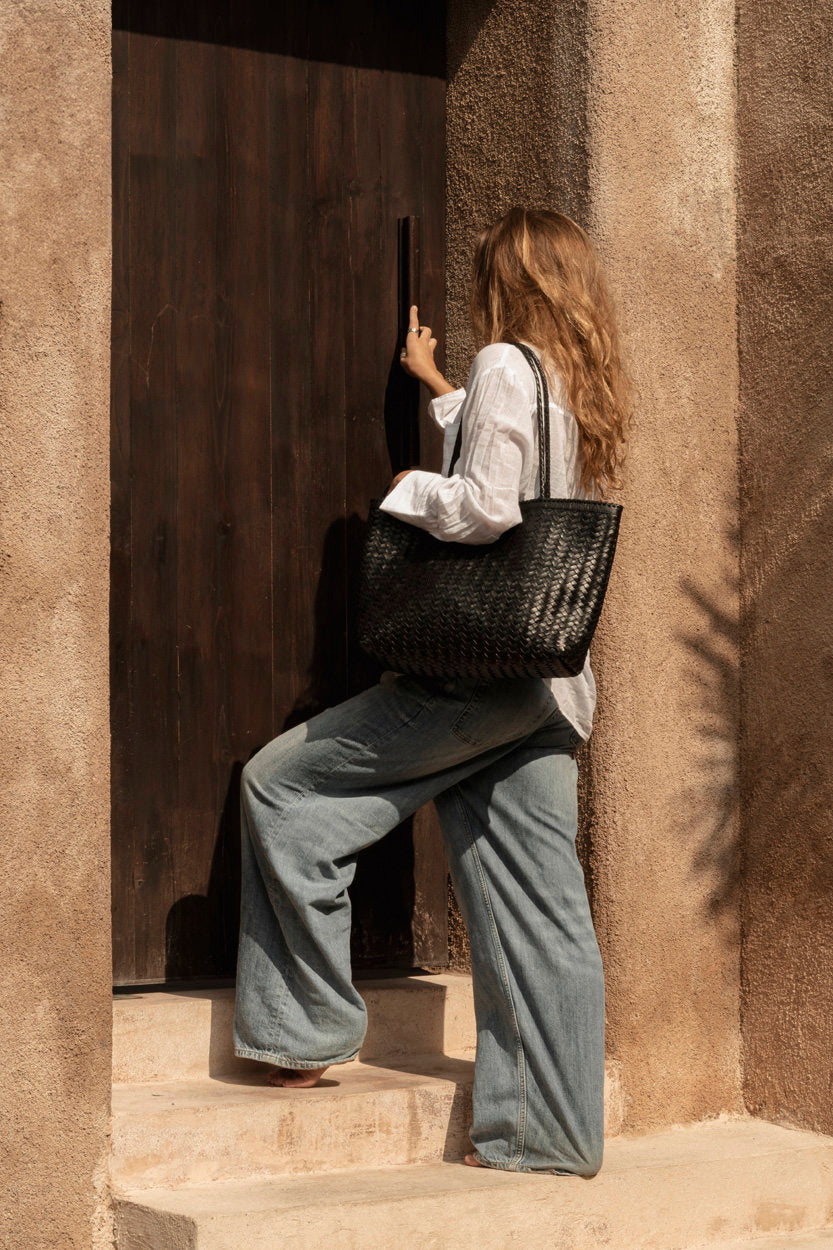 Hand-stitched leather tote combining elegance and practicality
