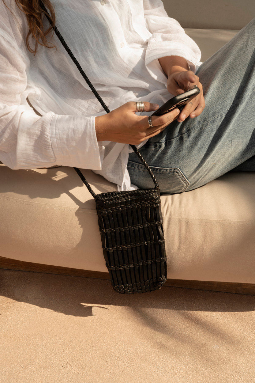 Durable leather phone bag with zip closure and compact design