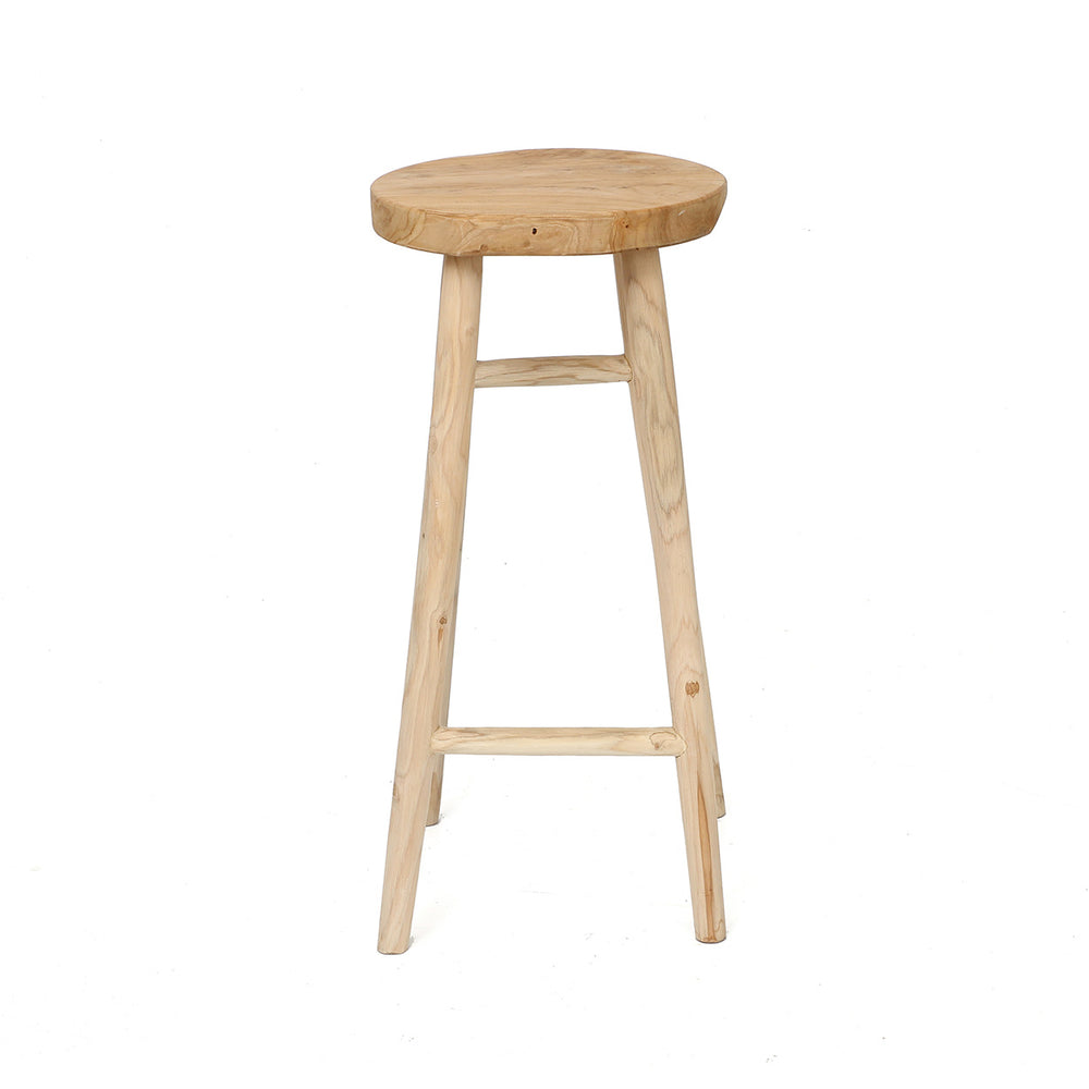 A minimalist artisanal teak kitchen stool with a round natural wood seat and a slender four-legged base with built-in wooden footrests.