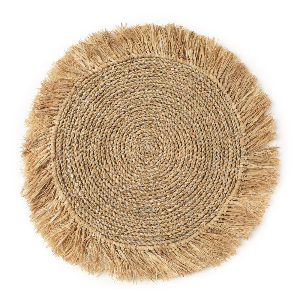 Natural fiber placemat handwoven from seagrass and raffia, perfect for adding rustic charm to your dining table.