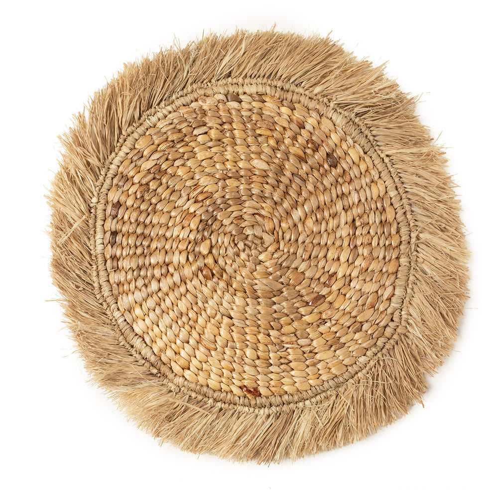 Handwoven water hyacinth placemat with raffia trim, ideal to add natural and sustainable charm to your dining table.