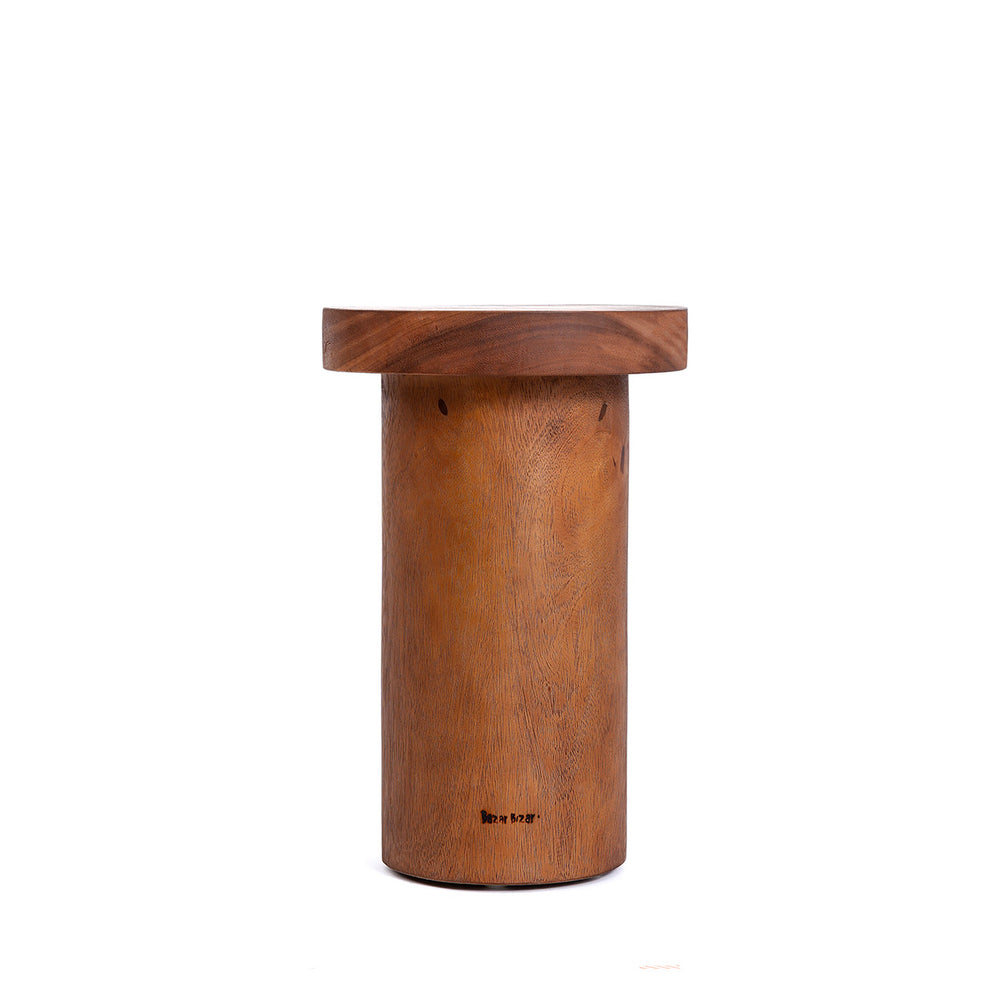 A wabi sabi side table in a natural hue with a round tabletop and pedestal base.