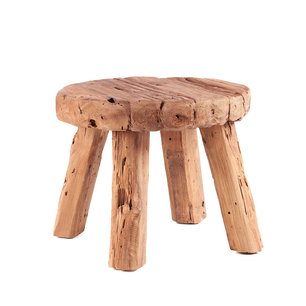 A solid teak log table with a rounded tabletop and four legs, embracing rustic style in natural colours.