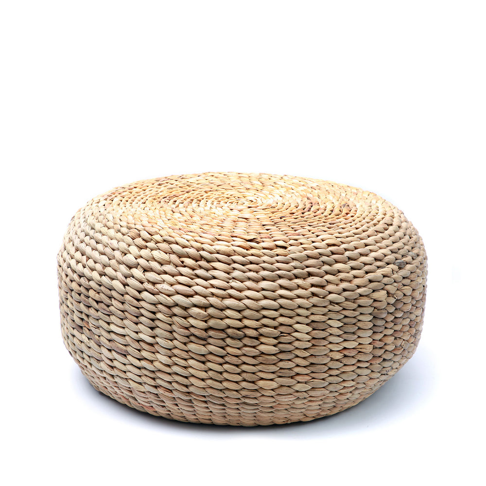 A 60 cm water hyacinth pouffe with intricate braided texture in warm golden wheat tones.