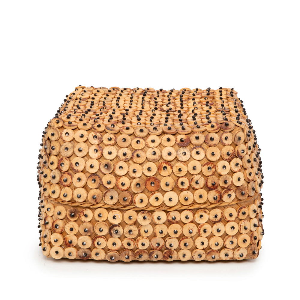 A handwoven natural lidded box in a large size, crafted from woven bamboo and adorned with circular coconut shell disc sequins secured with tiny dark beads.