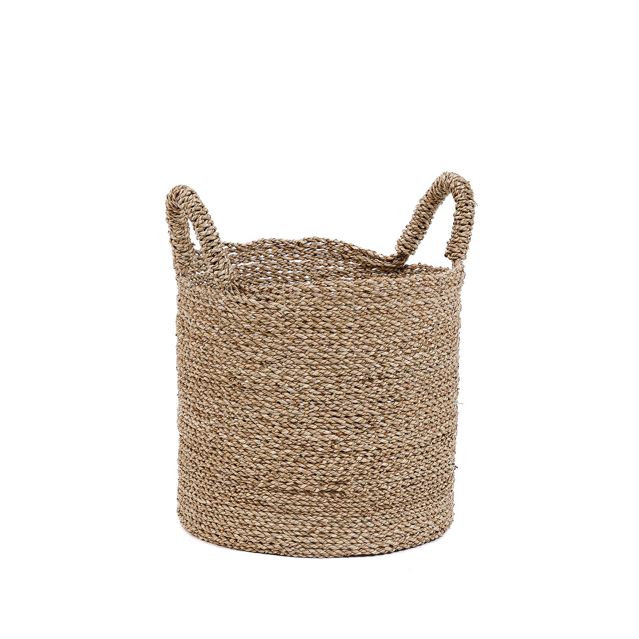 The medium basket sits low and grounded, its rounded form and natural fibers bringing a relaxed, tactile quality to the room