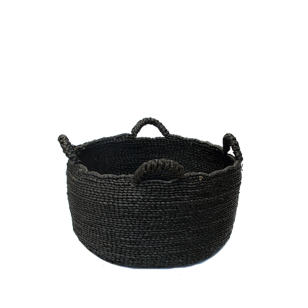 A chic black seagrass basket, handwoven from natural seagrass and featuring four braided handles.