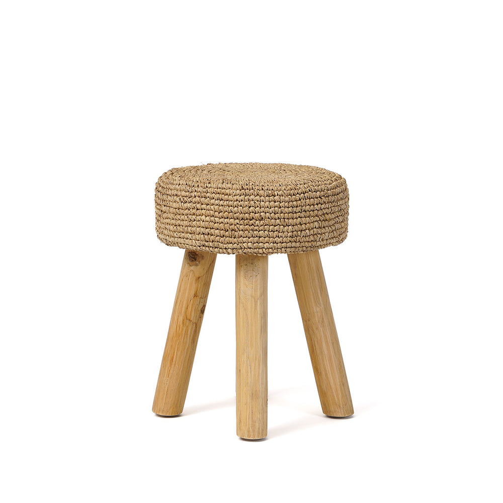 A rustic wooden vanity stool with a teak frame and a braided raffia seat, shown as extra living room seating.