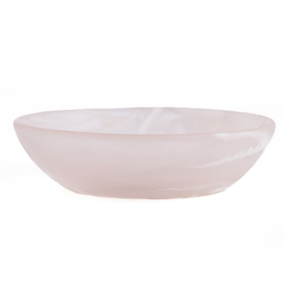 A swirled resin catchall bowl in translucent soft blush pink and milk white, designed with a shallow, wide basin.