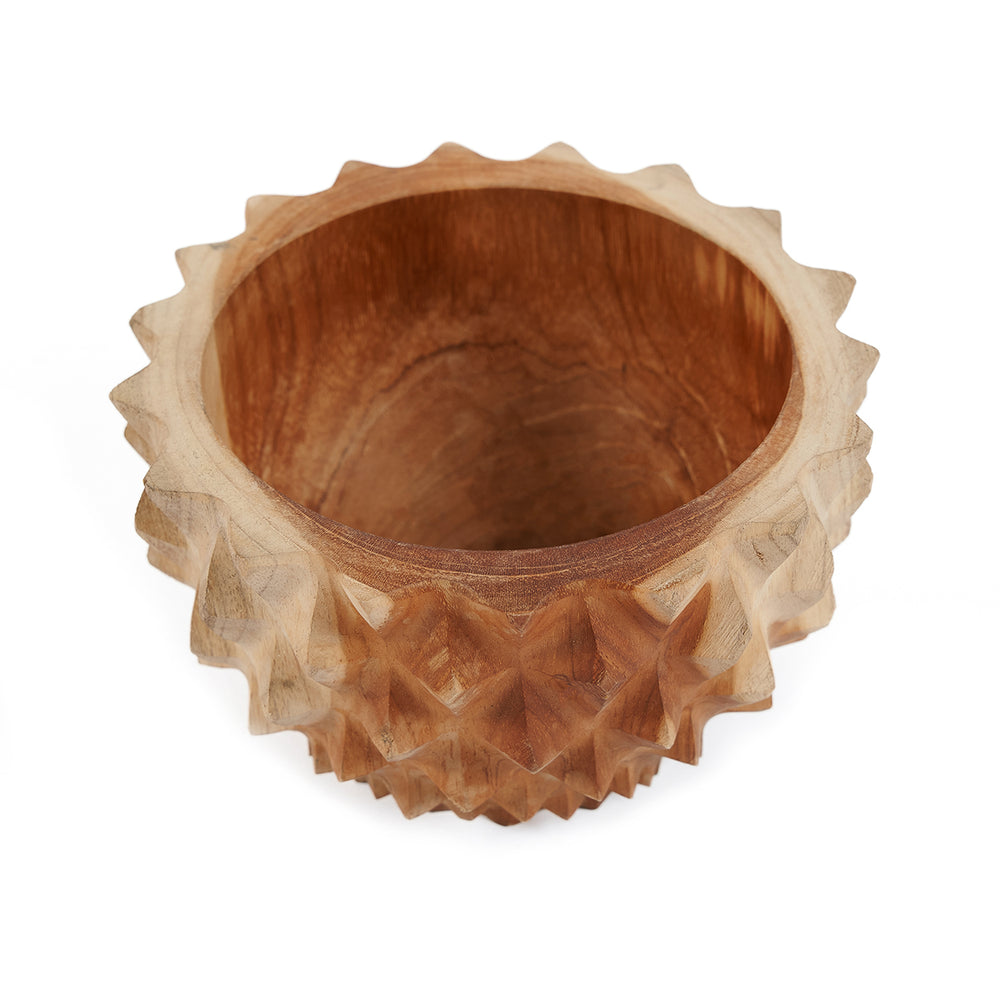 A small carved teak bowl in a compact, deep cylindrical shape with a faceted exterior like a durian husk.
