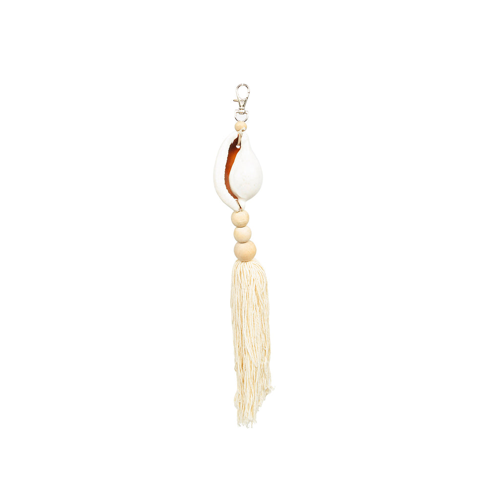 A natural white tassel keychain made from a big shell, wooden beads, and cotton fringe.