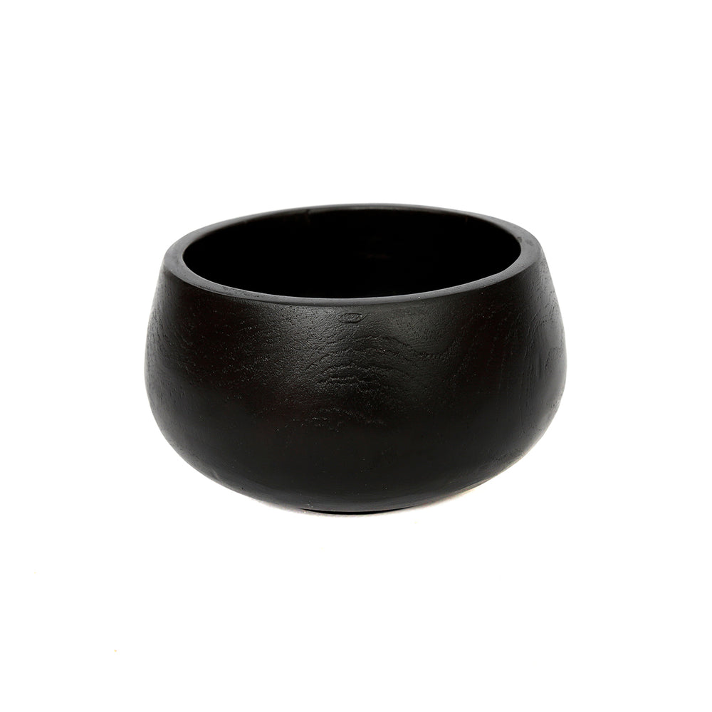 A handmade black teak bowl for dry snacks with a soft, rounded silhouette.