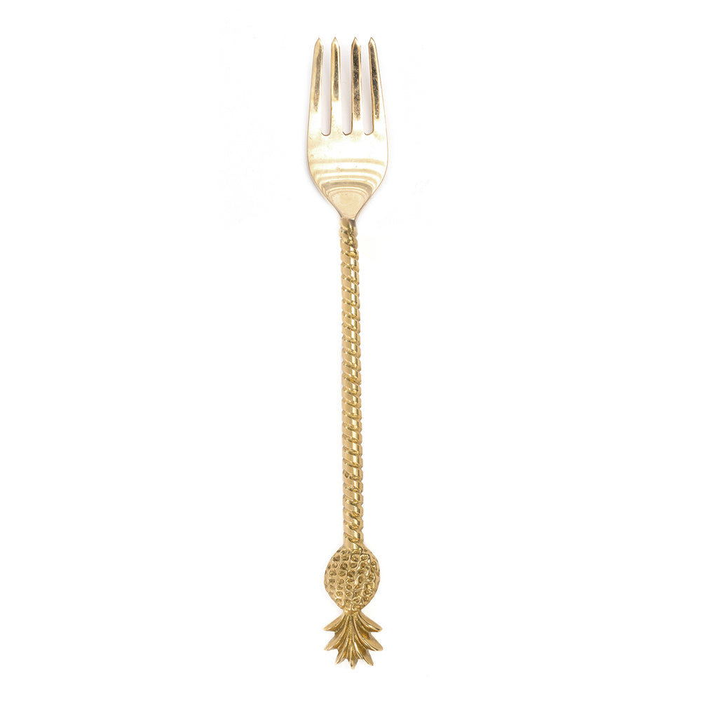 A brass pineapple fork in golden touch, decorative cutlery to serving fruits or salads.