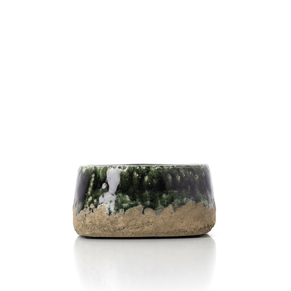 A low concrete green bowl planter, ideal for succulents and moss arrangements.