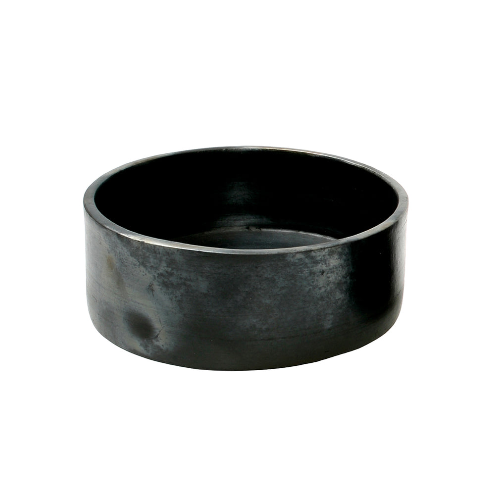 A handmade black terracotta bowl with a large, deep structure.