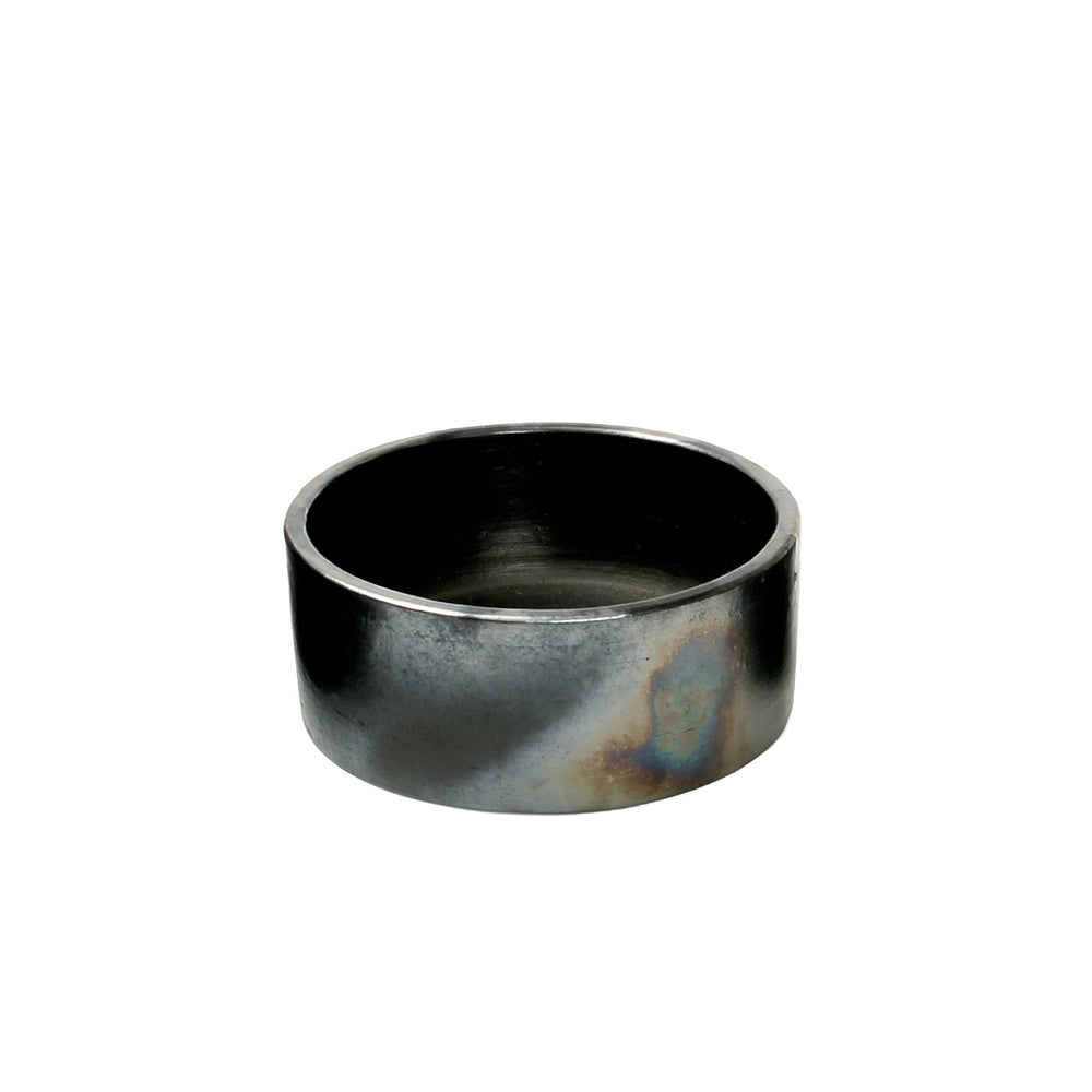 An artisan cylindrical serving bowl in black, crafted from terracotta in a medium size.
