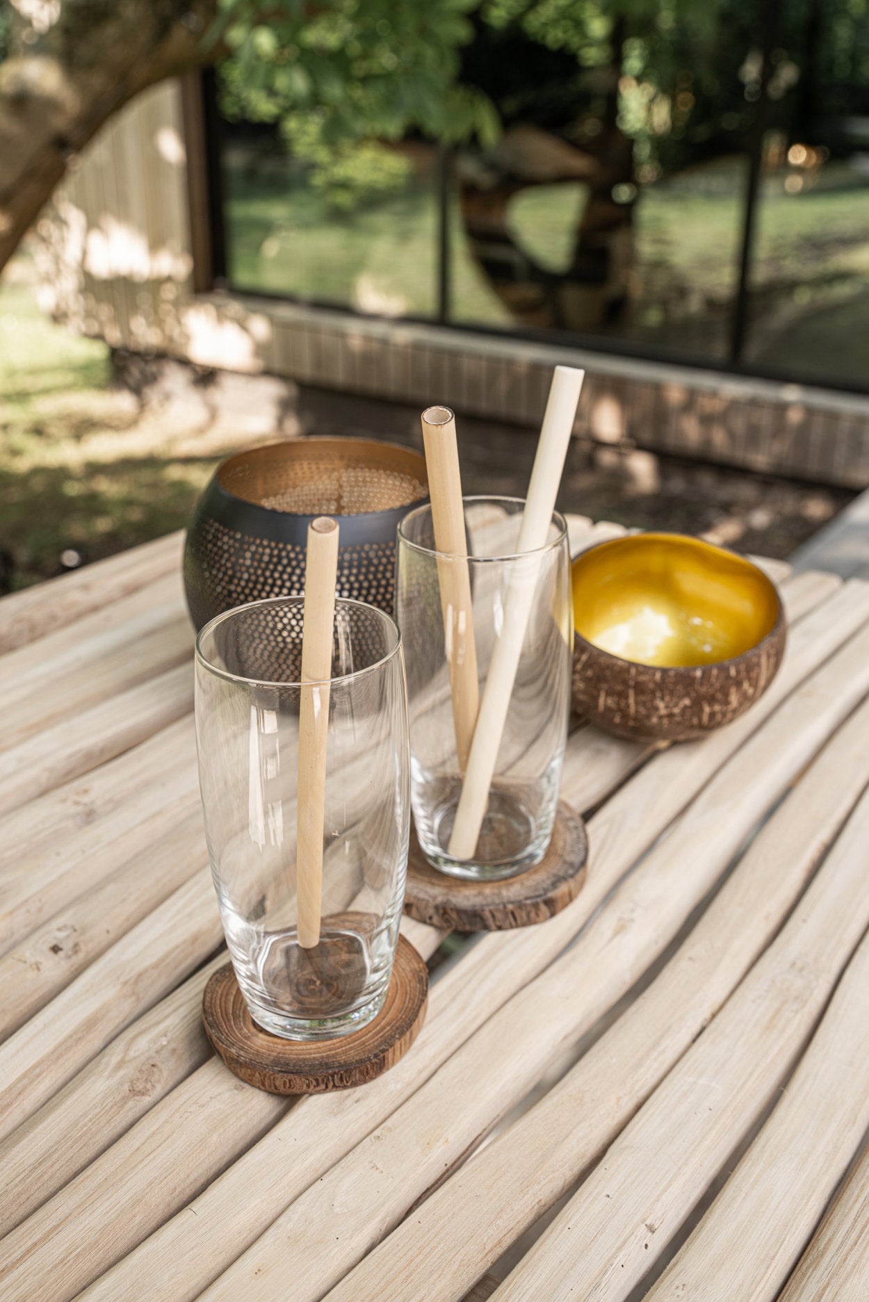 Small brass candle holder in black gold finish, artisan-made with pierced surface.