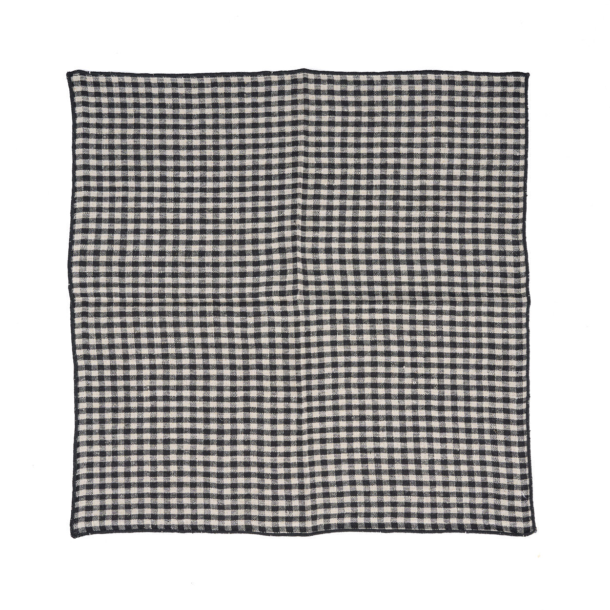 Compact checkered picnic napkin used as a base for a bread-and-jam snack outdoors.