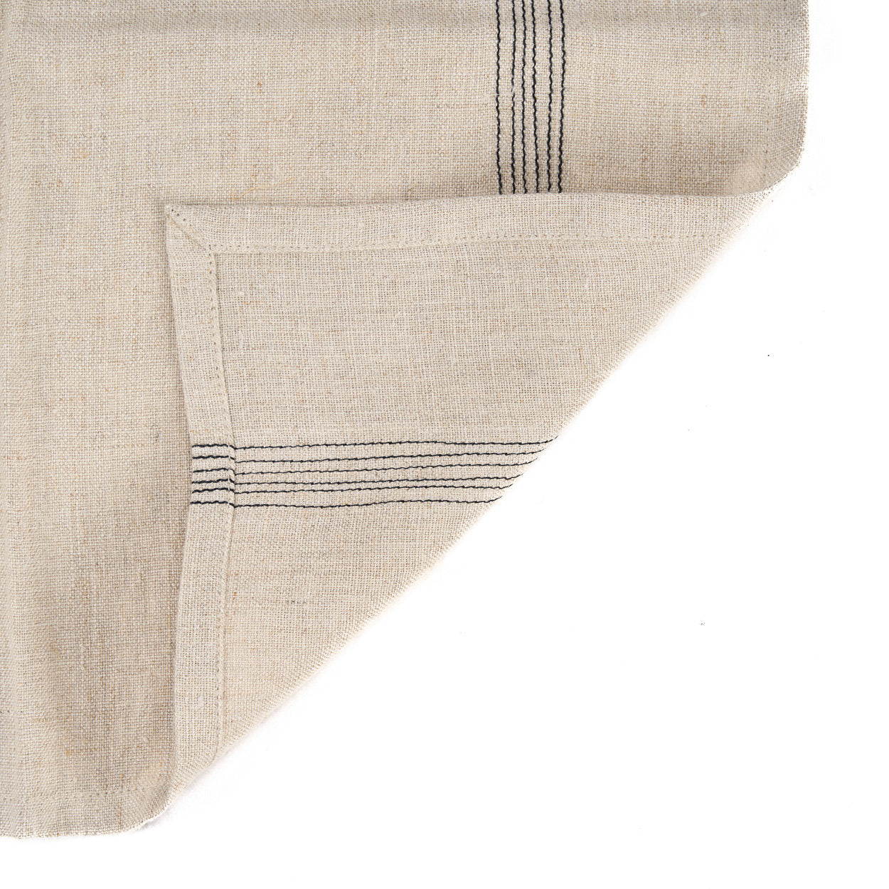 Close-up of natural linen napkin featuring subtle black stripes, showcasing its earthy texture and classic style.