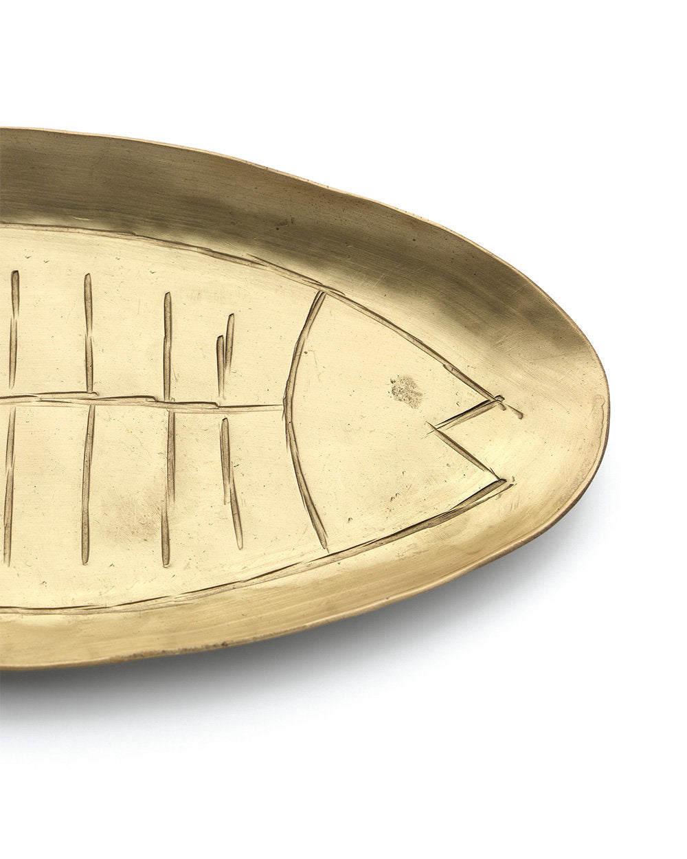 Artisan-made brass tray in whimsical fish silhouette, ideal for coastal, boho, or eclectic table settings.
