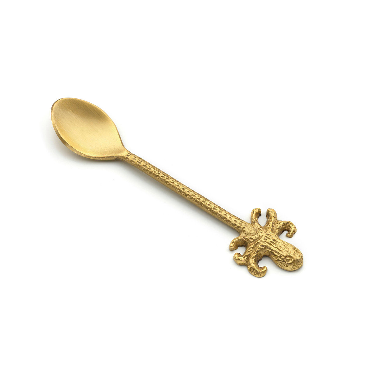 Close-up of handcrafted gold brass octopus spoon, highlighting smooth form and natural material variations.