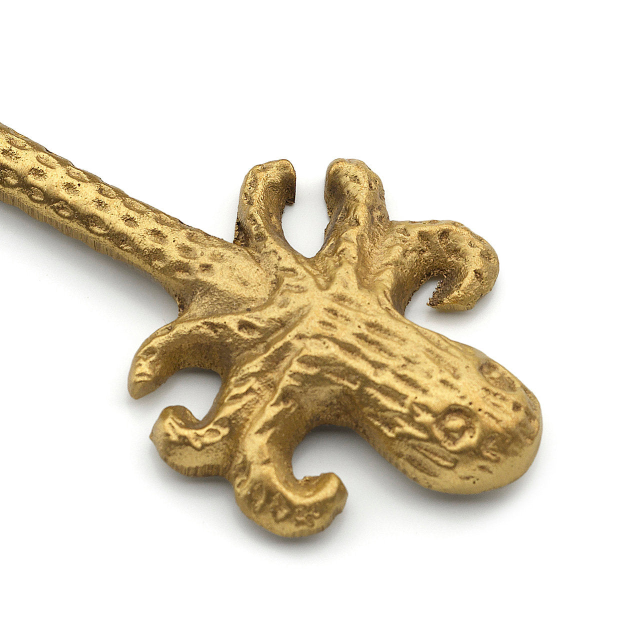 Small brass spreader knife with ocean-inspired octopus handle, great for appetizers.