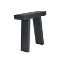 The black console table stands with quiet strength, its matte teak surface catching soft light that reveals the depth of its grain.
