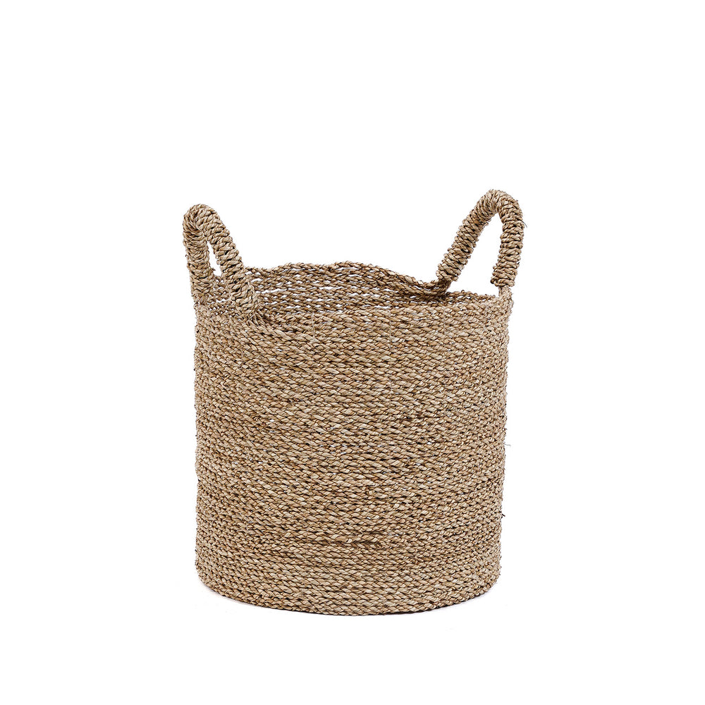 The medium basket sits low and grounded, its rounded form and natural fibers bringing a relaxed, tactile quality to the room