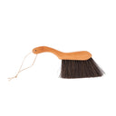 The Lawa Brush, a wooden cleaning brush with ergonomic handle to clean the dust