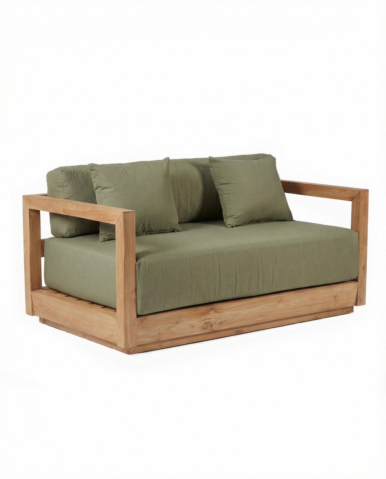 Set against soft greenery, this wooden outdoor sofa rests in reclaimed teak, its green cushions catching the light in a quiet garden setting.