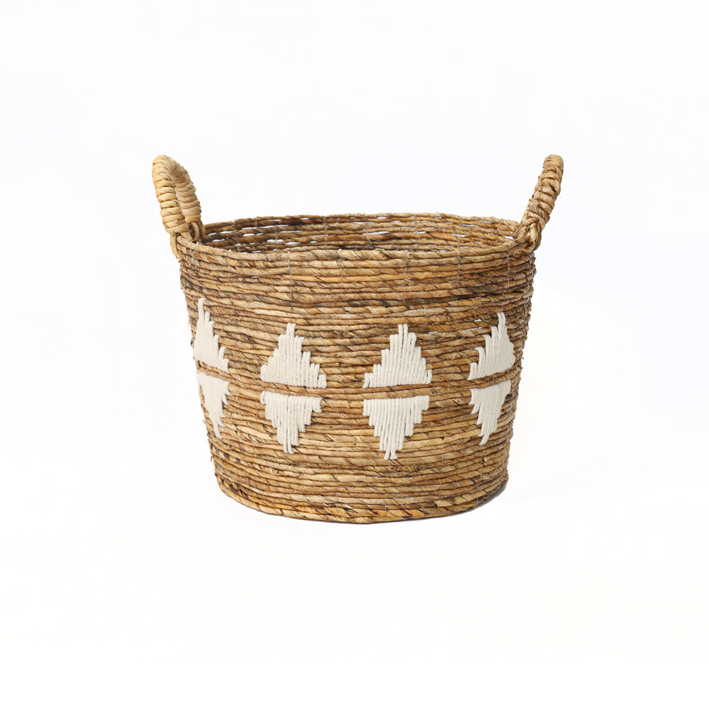 Medium woven basket in banana leaf fiber with white diamond embroidery.