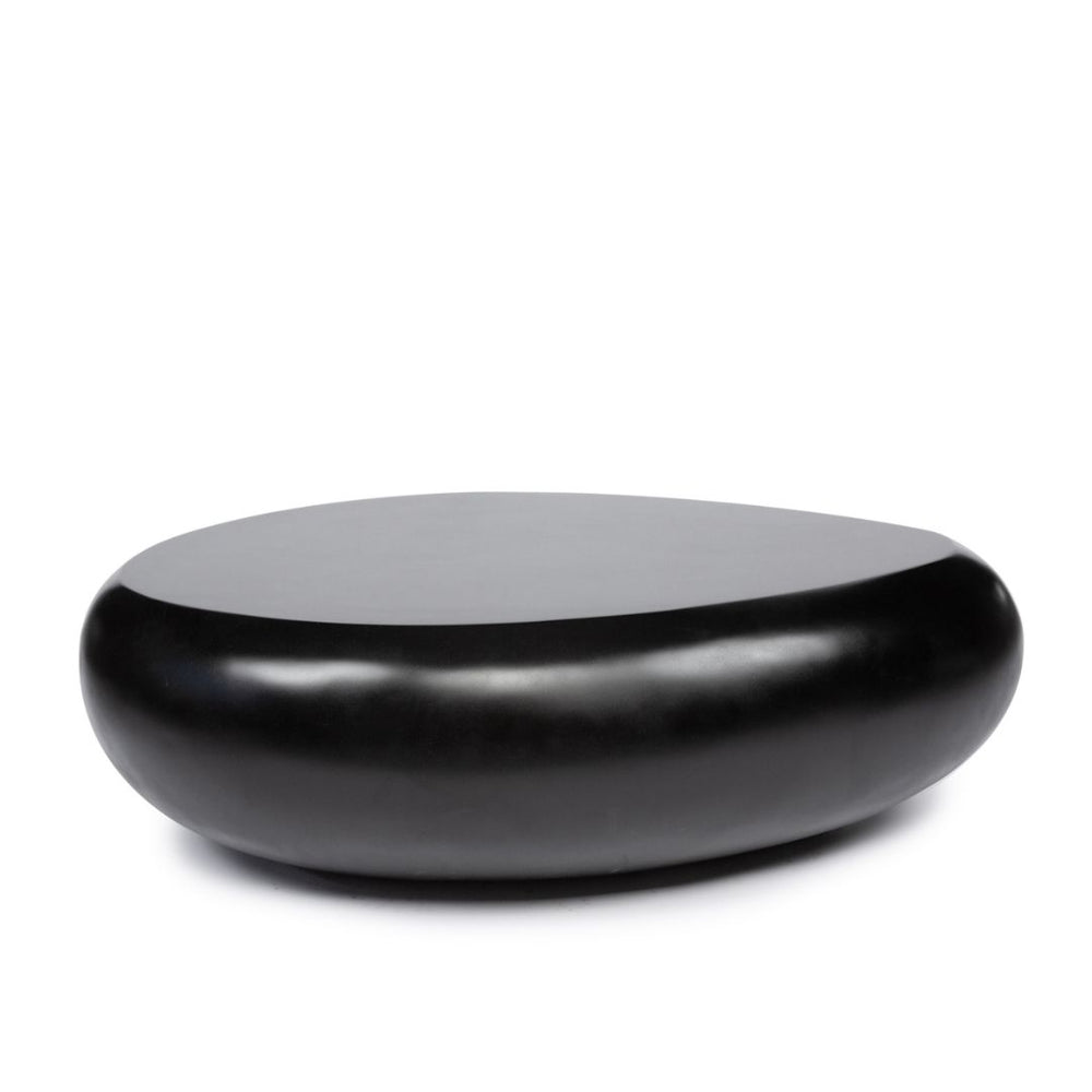 A black coffee table made from resin in matte finish and round form, stands for elegance and sophisticated room.