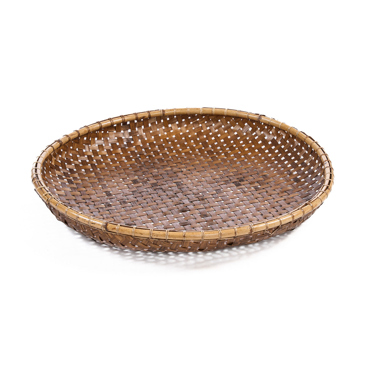 A medium bamboo tray in round form and natural brown colour, handwoven by craftspeople in Indonesia.
