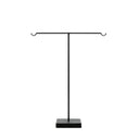 A black metal jewelry and key stand with upward-curved ends and a stable square base.
