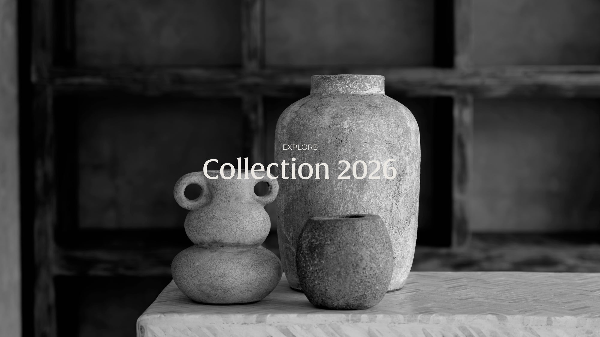 Three stone vases on a wooden surface with 'Collection 2026' text.